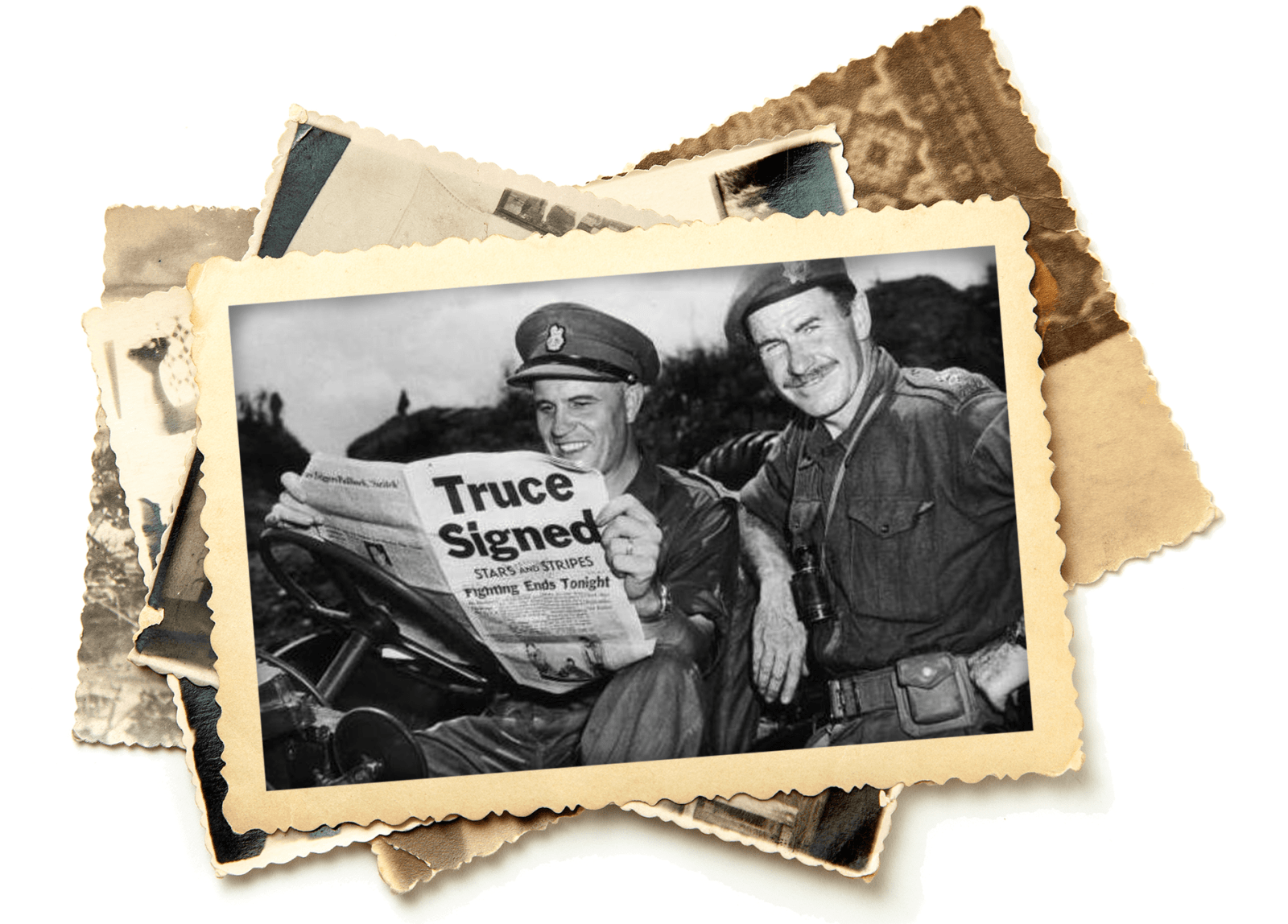 A black and white image of two men in military uniforms. The one of the left is reading a newspaper with a bold headline “Truce Signed” while the man on the left, Colonel K. L. Campbell, smiles while looking at the camera.
